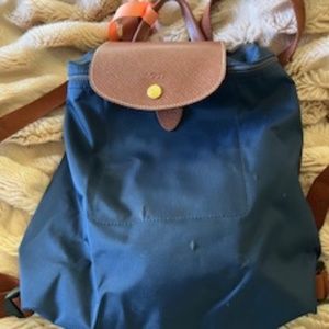 Longchamp Navy Le Pliage Backpack with brown flap and handles